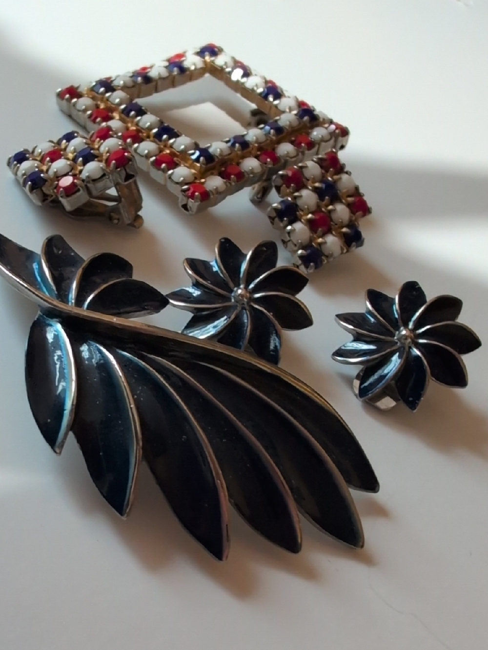 2 sets of brooches and matching clip on earrings